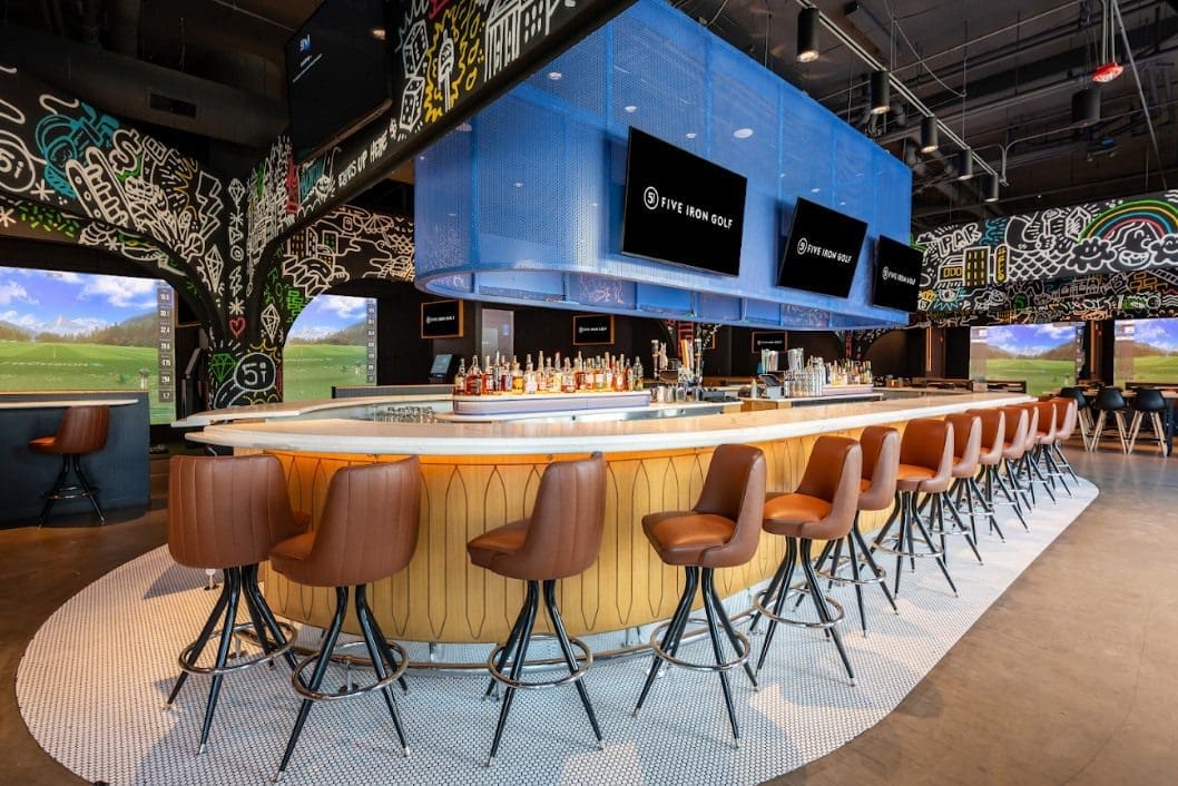 Simulator bays and bar at Five Iron Golf in Bucktown, Chicago
