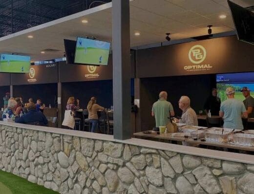 Bar with simulator bays behind at Optimal Performance Golf in Maple Grove, MN