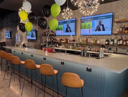 The bar with TVs overhead at Five Iron Golf in Norwalk, CT