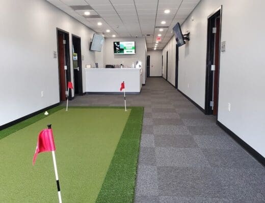Putting green in the hallway by the front desk at GolfCave in Flemington, NJ