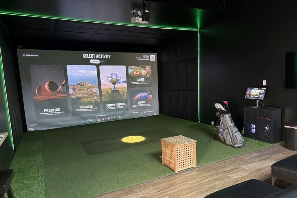 Trackman simulator bay with green LED trim at Hive Golf in Bountiful, UT